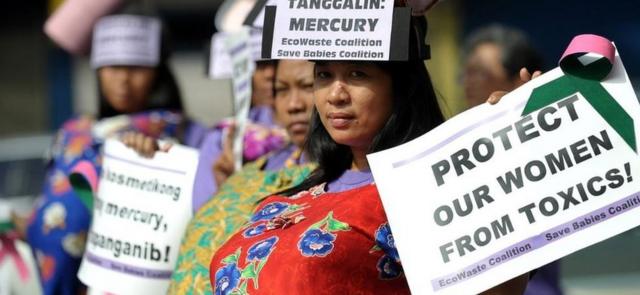 Filipino women dressed as pregnant mothers protest against imported Chinese cosmetics in Manila