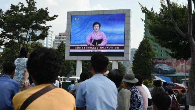 Norcoreanos mirando la televisión estatal.