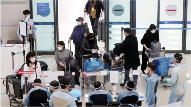 28일 오후 인천국제공항 제1여객터미널 입국장에서 일본 오사카에서 출발해 입국하는 여행객들이 공항 방역 관계자들과 문답을 나누고 있다