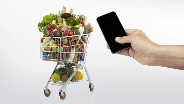 The concept of someone paying for groceries with a mobile phone