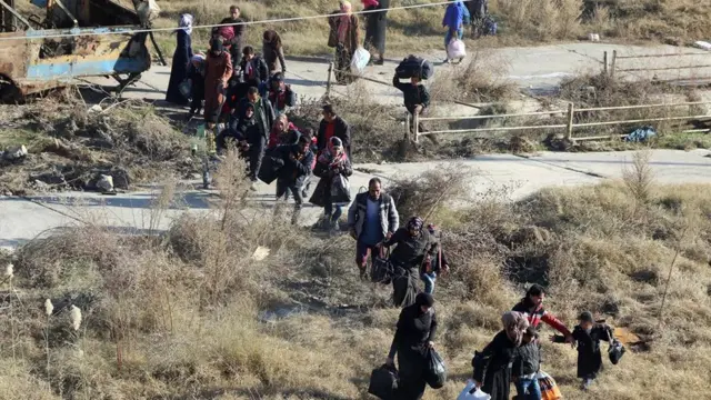 People flee rebel-held eastern neighbourhoods of Aleppo into the Sheikh Maqsoud area that is controlled by Kurdish fighters - photo provided by the Rumaf, a Syrian Kurdish activist group (27 November)