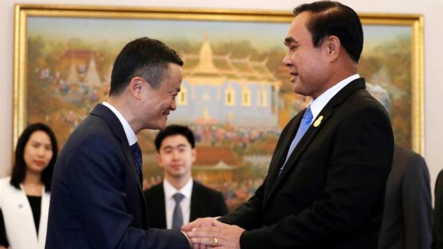 Jack Ma shakes hands with Thailand"s Prime Minister Prayuth Chan-ocha in Bangkok