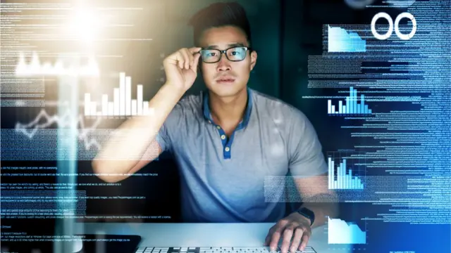 Man surrounded by digital screens