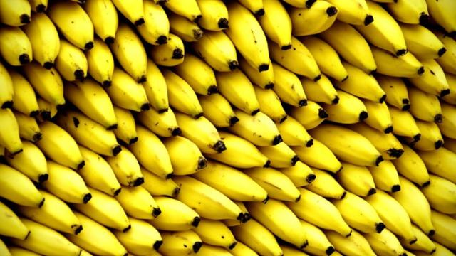 Bananas piled up in a market stall