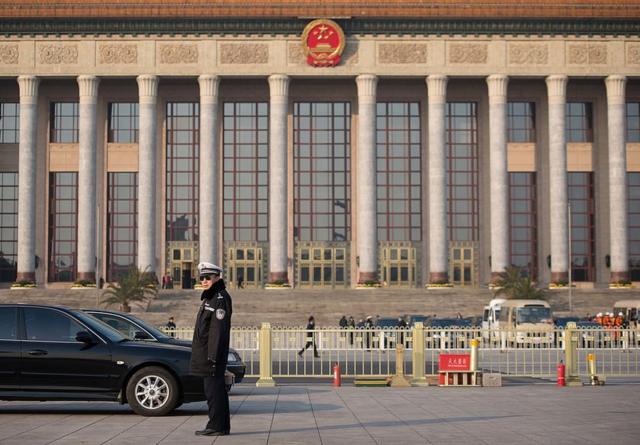A policeman stands guard outside the Great Hall of the People prior to the unveiling of a new Politburo Standing Committee, in Beijing on 15 November 2012.
