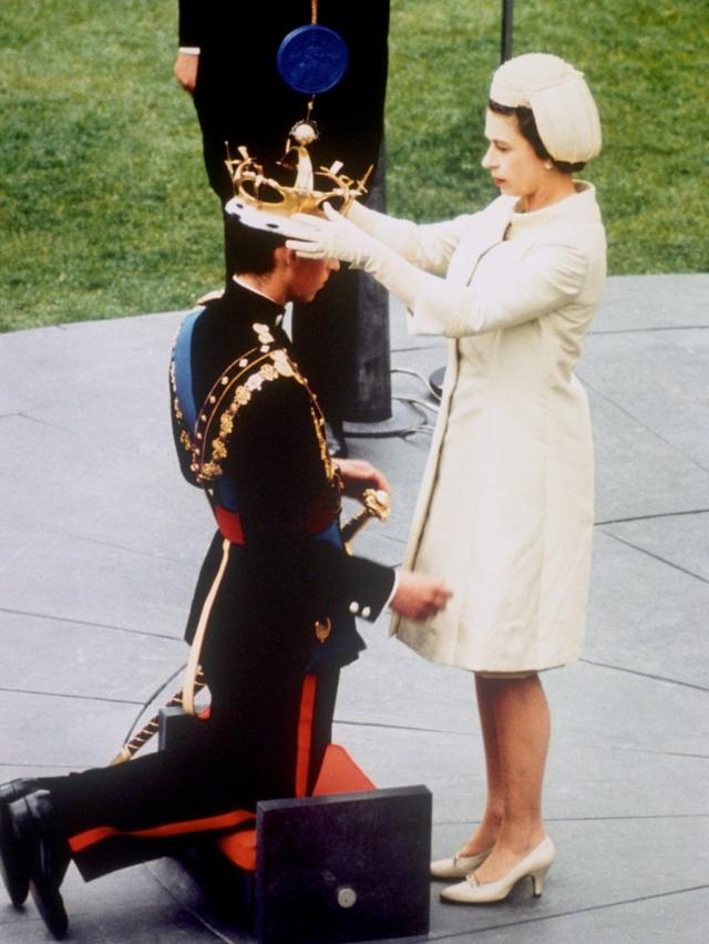Queen Elizabeth II investing her son, Prince Charles