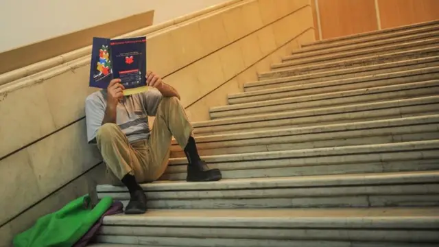 مردی در حال خواندن کتاب