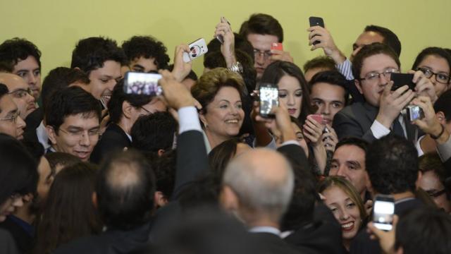 A ex-presidente Dilma Rousseff cercada de alunos contemplados com o Ciência Sem Fronteiras durante lançamento da segunda fase do programa em junho de 2014