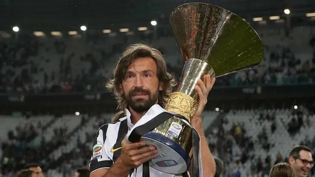 Andrea Pirlo holds up the Serie A trophy while a player for Juventus