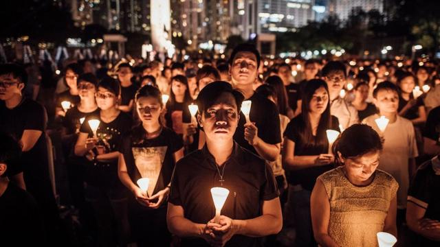Participants take part at the candlelight vigil as they hold candles at Victoria Park on June 4, 2015 in Causeway Bay, Hong Kong.