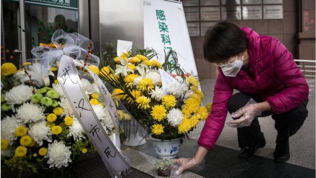 FEBRUARY 07: A resident bring bouquets of flowers to pay tribute to Dr. Li Wenliang at Li's hospital