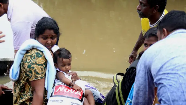 People take a boat to safety in Kochi