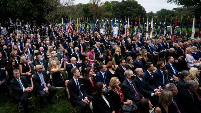 Attendees sitting close together at a Rose Garden ceremony in September