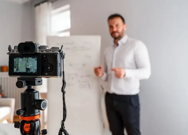 One male professor holding online class for e-learning students during coronavirus pandemic period. - stock photo