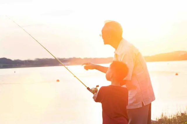 A boy and a grandfather fishing