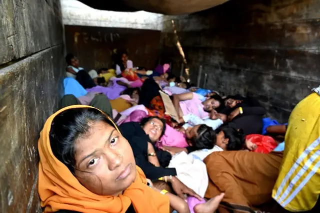 TOPSHOT - Rohingya refugees sit on a truck after being relocated from Southern Aceh province to Banda Aceh on November 7, 2024. (Photo by CHAIDEER MAHYUDDIN / CHAIDEER MAHYUDDIN/AFP / AFP) (Photo by CHAIDEER MAHYUDDIN/CHAIDEER MAHYUDDIN/AFP/AFP via Getty Images)
