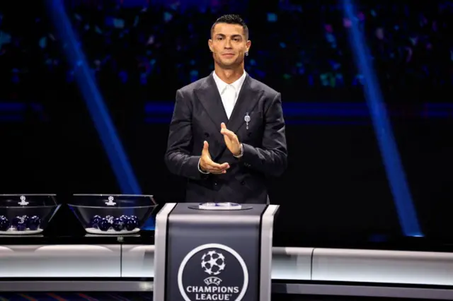 Portugal's national team player and Saudi Al-Nassr's forward Cristiano Ronaldo applauds on stage during the ceremony of the draw for the group stage of the 2024-2025 Uefa Champions League football tournament, at the Grimaldi Forum in Monaco on August 29, 2024.
