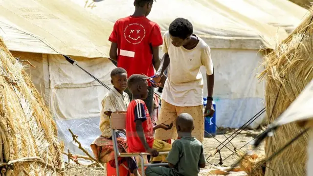 A boy gets a haircut on Wednesday in a camp in Gedaref in eastern Sudan
