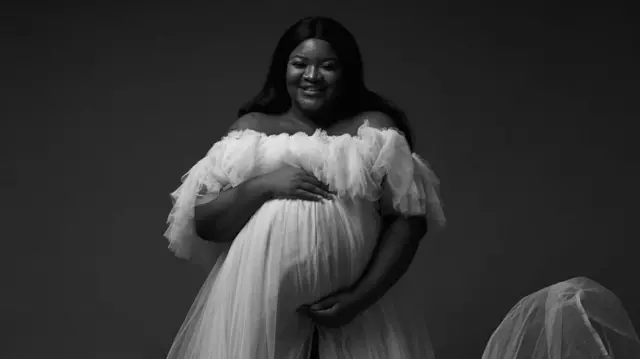 A black and white image of a pregnant woman