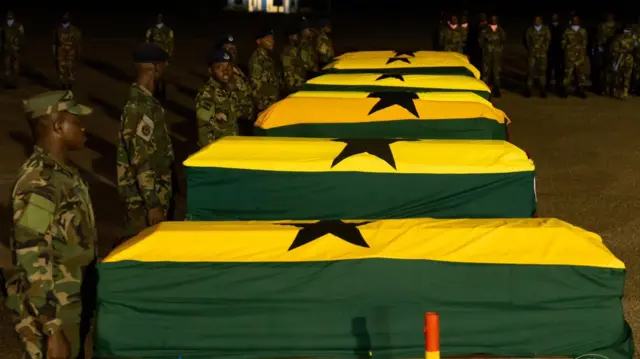 Caskets of di eight victims wey dem cover in Ghana colours 