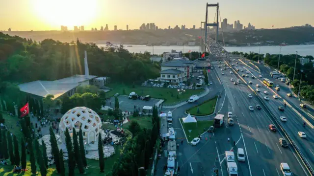 15 Temmuz Şehitler Köprüsü'nün Anadolu Yakası girişinde bulunan 15 Temmuz Şehitler Makamı ve Hafıza 15 Temmuz Müzesi'nin havadan görüntüsü. Fotoğrafta bu mekanlar dışında İstanbul Boğazı, köprüdeki araçlar ve Avrupa yakasının silüeti de görülüyor.