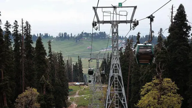 Tourists take a gondola ride at the ski resort in India-administered Kashmir