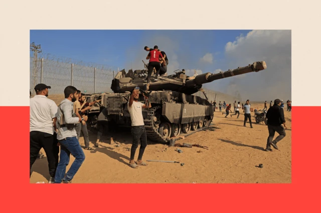 Palestinians climb on an Israeli Merkava battle tank after crossing the border fence with Israel from Khan Yunis in the southern Gaza Strip 