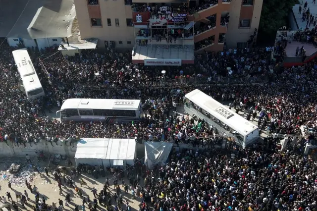 Vista aérea de las miles de peronas concentradas en el Hospital Nasser de Jan Yunis para recibir a los prisioneros palestinos liberados por Israel. Hay varios autobuses estacionados también.