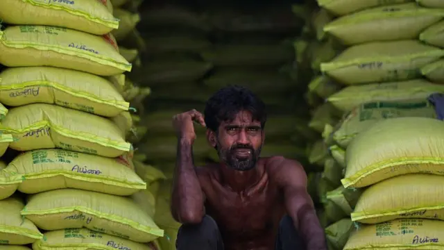 A man in the middle of rice packets