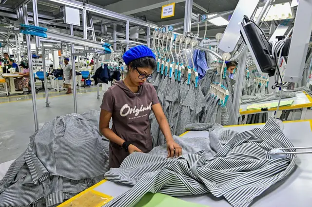 An employee performs quality checks on garments inside a garment factory in Katunayake free trade zone