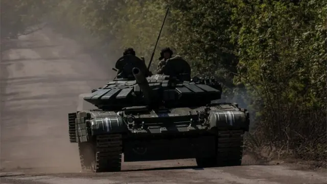 جنود أوكرانيون فوق دبابة على طريق إلى بلدة باخموت، وسط هجوم روسيا