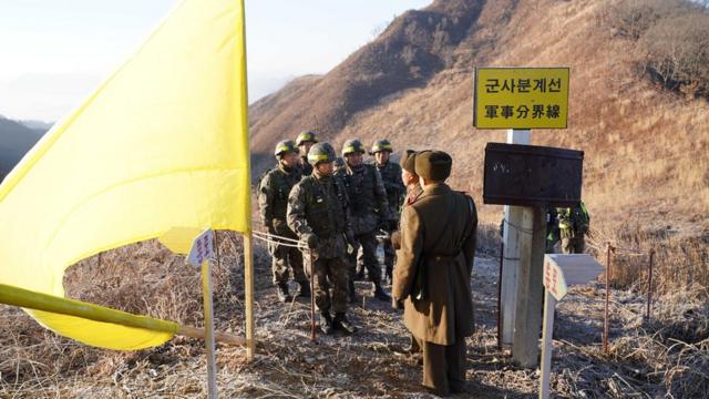 North and South Korean soldiers approaching each other at the inter-Korean border