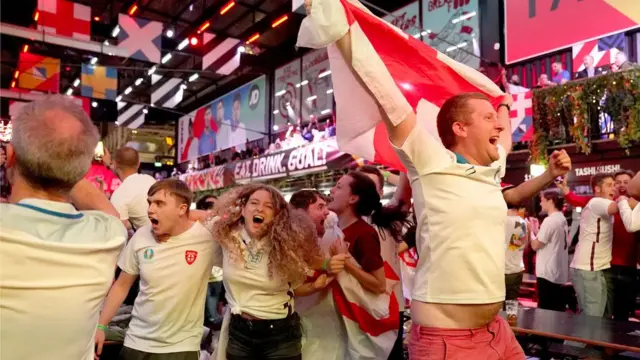 Fans at BOXPARK in Croydon celebrate England reaching the final after watching the Euro 2020 semi final match between England and Denmark.