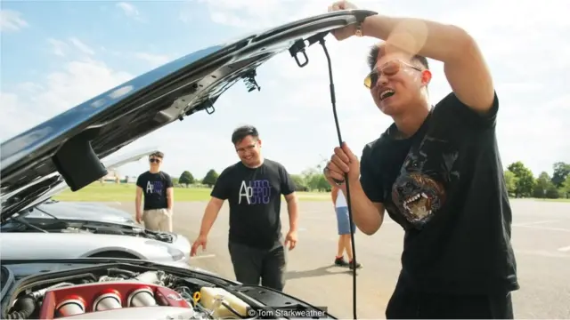 Shawn Mao opens the hood of his 2015 Nissan GTR