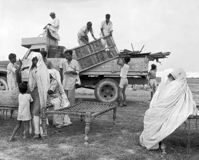 Korangi near Karachi : Muslim refugees from India unloading their belongings from a truck in a new colony built by the Pakistani government.