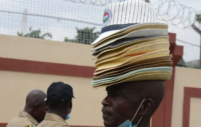 And on Wednesday a hawker in the Nigerian city of Lagos tries to sell hats to protesters opposing calls to reduce the country's minimum wage set at ($65; £45) a month.