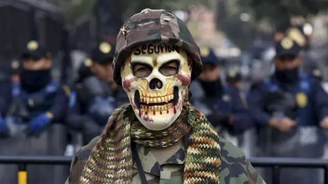 Hombre protesta contra la ley para regularizar la presencia militar en las calles mexicanas.