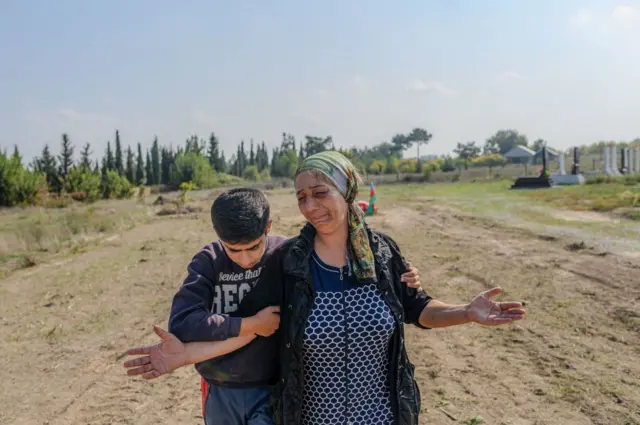 Aybeniz Khasanova beside the grave of her son