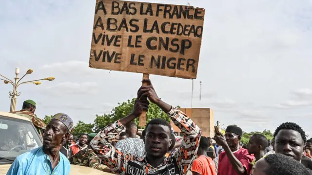 Pro-coup demonstrators holding placards denouncing France and regional body Ecowas