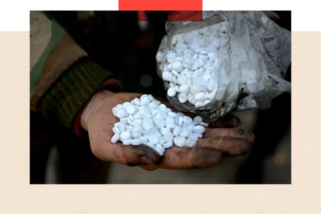 A treated image shows a dirty hand holding a pile of white pills, being poured from a bag