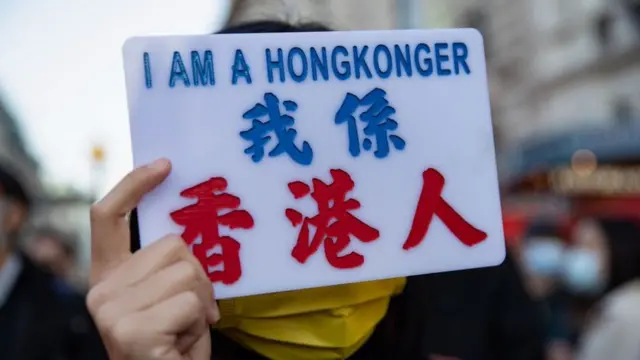 A woman holds a sign reading "I am a HongKonger"
