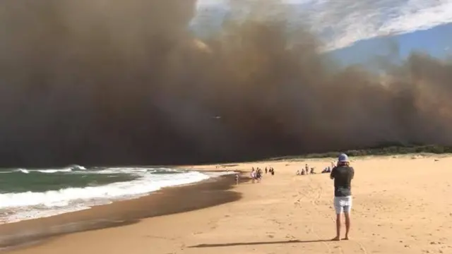 The Tathra blaze seen along the coastline on Sunday afternoon as residents evacuated