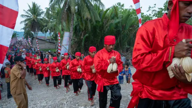 Masyarakat adat Batui membawa telur Maleo (Macrocephalon maleo) yang dibungkus daun lontar pada upacara adat Tumpe di Desa Batui, Kabupaten Banggai.