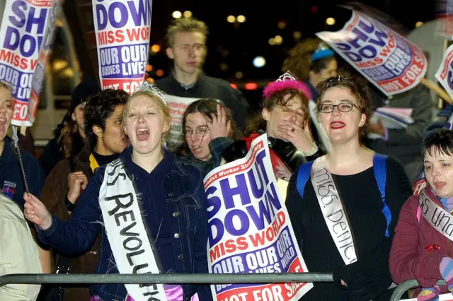 A group of anti-Miss World protesters shout slogans in front of London's Millenium Dome, 30 November 2000. The demonstrators made their feelings heard to the crowd arriving at the Dome to attend the Miss World final