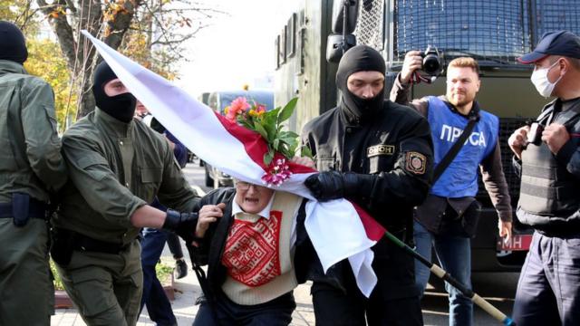 Law enforcement officers detain an opposition activist Nina Baginskaya
