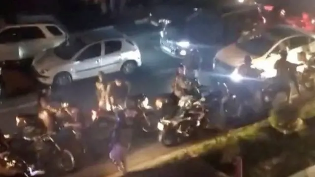 Screengrab of video showing people running during clashes between riot police as students in Tehran, Iran (2 October 2022)