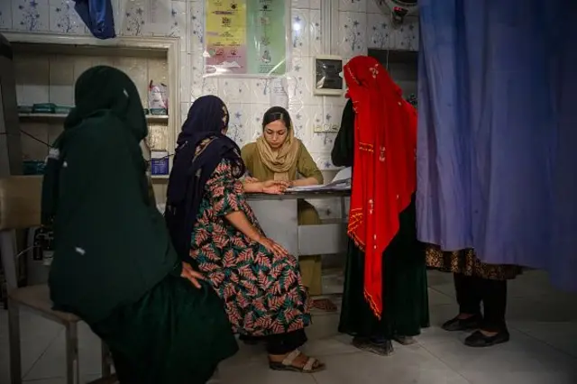 Medical doctor and surgeon Bibi Khadija Sadat, 35, registers patients at the provincial hospital's maternity unit on August 27, 2025, in Ghazni, Afghanistan