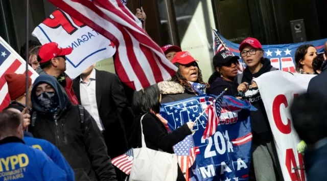 Plusieurs supporters de Trmp avec drapeaux, banderoles et casquettes à l'effigie de l'ancien président