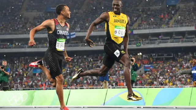 Усэйн Болт и канадец Андре де Грассе в полуфинальном забеге 200-метровки