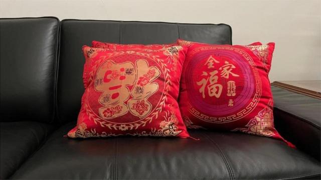 Several Chinese New Year patterned pillows in Charlenne's living room are always placed on the sofa.